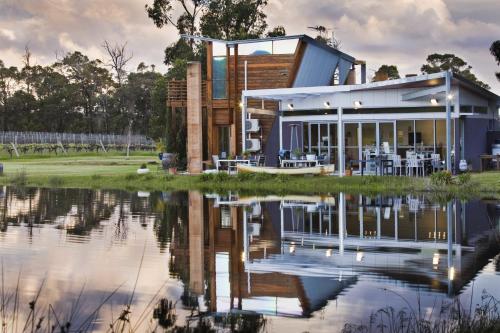 a house with a pond in front of it at Bettenays Margaret River in Metricup