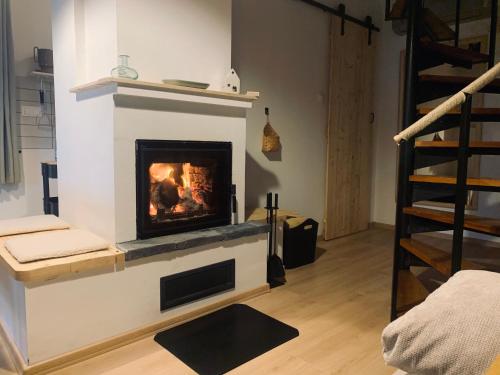 a living room with a fireplace in the wall at Fügéskert in Balatongyörök