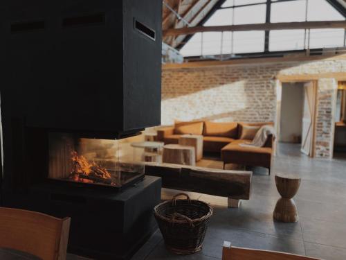 a living room with a fireplace and a couch at BarnHaus in Jibert