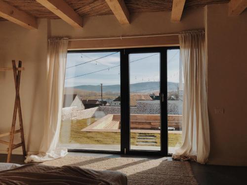 a bedroom with a large glass door with a view at BarnHaus in Jibert