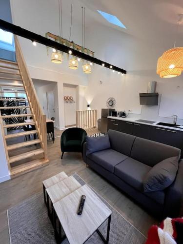 a living room with a blue couch and a table at LOFT DU BRAS DOR in Boulogne-sur-Mer