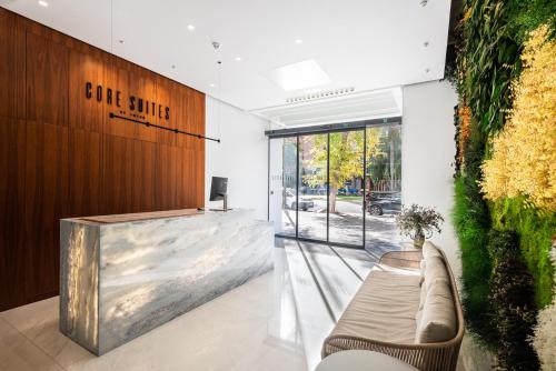 a lobby with a couch and a sign that reads one smile at Apartamentos Core Suites Valencia in Valencia