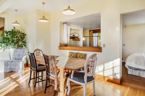 a dining room and living room with a wooden table and chairs at Milagra Guest House in Lopez