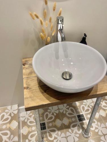 a white sink on a wooden counter in a bathroom at Harbour View House in St Ives