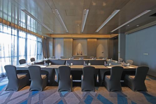 a large conference room with a large table and chairs at Wyndham JinJiang Hotel in Jinjiang
