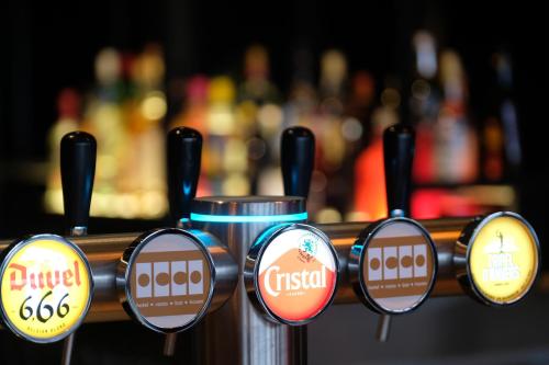 a group of signs on a rack in a bar at OccO in Willebroek