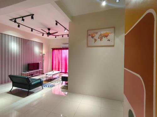 a living room with a black chair and a television at Pavilionvillie M1T570 by irainbow in Ipoh