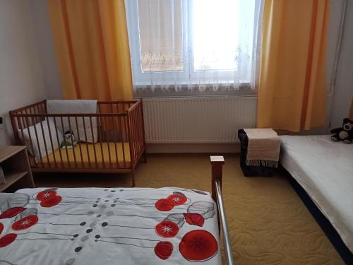 a bedroom with a bed with red roses on it at U Tabáčka in Hradčovice