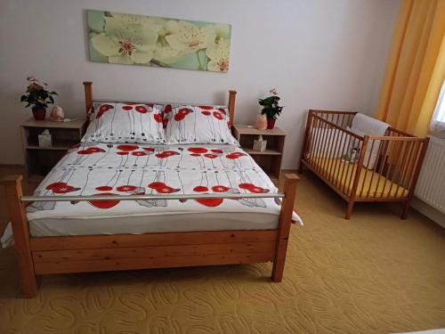 a bedroom with a bed and a crib in it at U Tabáčka in Hradčovice