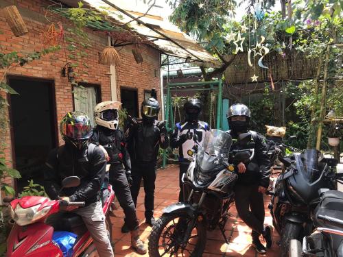 a group of motorcyclists are standing next to their motorcycles at Green Sunshine Homestay in Can Tho