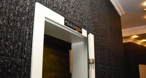 a door to a building with a sign above it at Hotel PALACE in Velika Kladuša