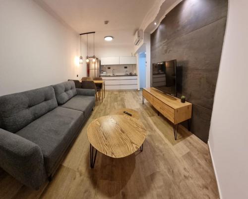 a living room with a couch and a table at Kings Towers in Tiberias