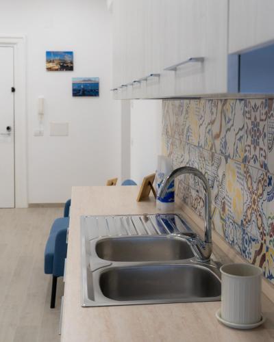 uma cozinha com um lavatório e uma bancada em Dimora Cavour em Nápoles