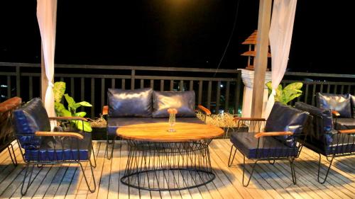 a patio with a table and chairs and a couch at Nakasang Paradise Hotel in Nakasong