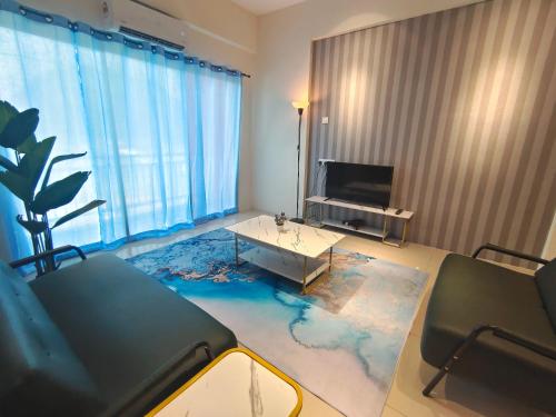a living room with a table and a tv at Pavilionvillie M1T584 by irainbow in Simpang Pulai