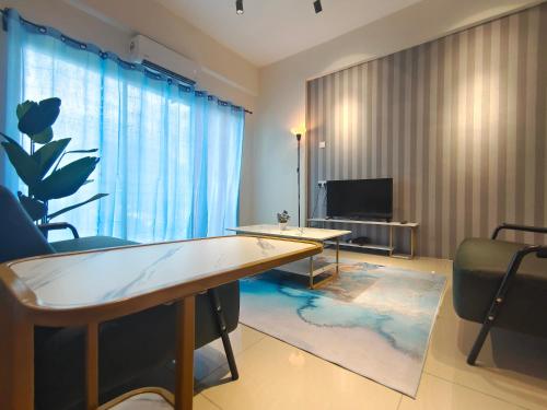 a living room with a table and a tv at Pavilionvillie M1T584 by irainbow in Simpang Pulai