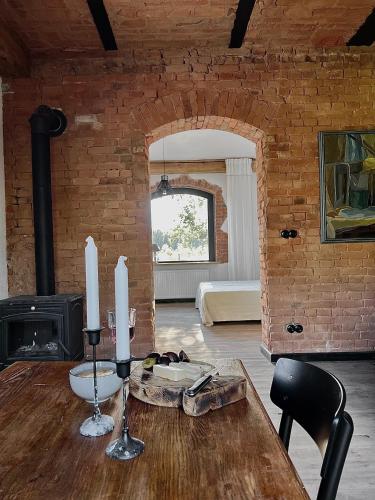 a room with a wooden table with two candles on it at Ublik Stacja in Ublik