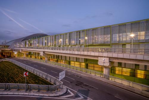 a large building with a road in front of it at TAV Airport Hotel Izmir in Izmir