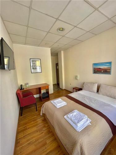 a hotel room with a bed and a desk at Rooms Sonata in Kyustendil