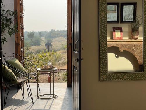 a view of a room with a table and a mirror at Kaner Retreat - India's First Desert Botanical Resort in Shaitrāwa