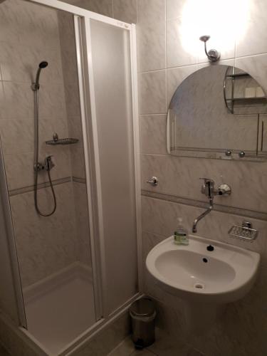 a bathroom with a shower and a sink and a toilet at Penzión Šafran in Stratená
