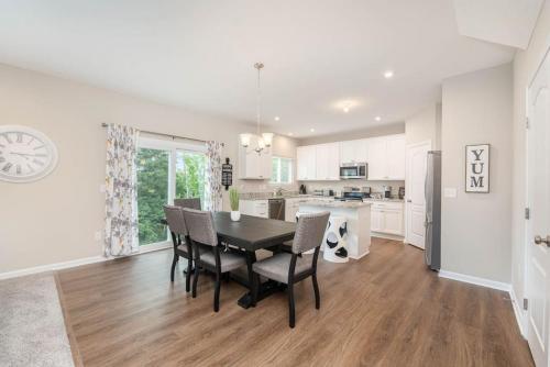 a kitchen and dining room with a table and chairs at 1344 soaring way NEW Cheerful 5 bedroom home in quiet suburban area in Maineville