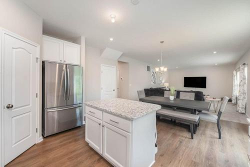 a kitchen and living room with a table and a kitchen and a dining room at 1344 soaring way NEW Cheerful 5 bedroom home in quiet suburban area in Maineville