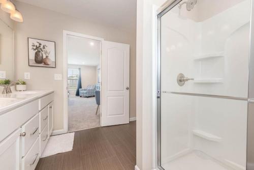 a bathroom with a shower and a sink at 1344 soaring way NEW Cheerful 5 bedroom home in quiet suburban area in Maineville