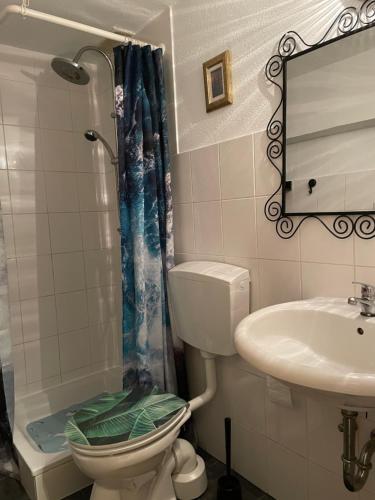 a bathroom with a toilet and a sink at Köln Apartment I in Cologne