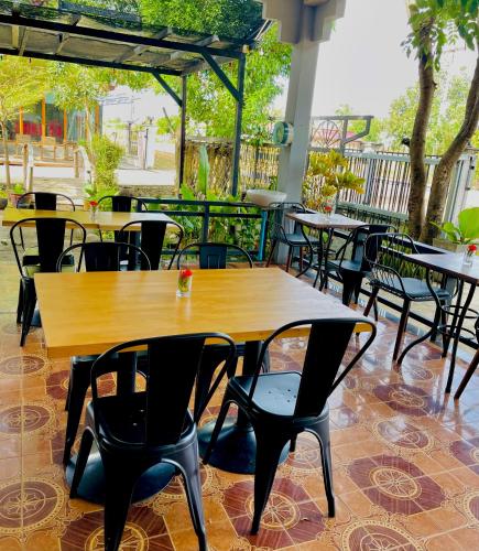 a group of tables and chairs in a restaurant at Nakasang Paradise Hotel in Nakasong