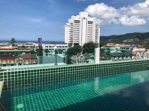 a swimming pool on the roof of a building at I Am O'TEL PATONG Managed by Priew Wan Guesthouse in Patong Beach
