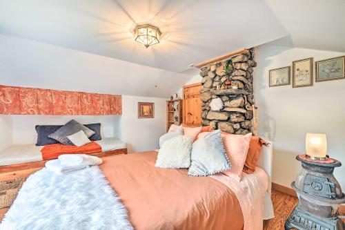 a bedroom with a large bed and a stone wall at Old Time Catskill Mtn Retreat, Handcrafted Cabin! in Cornwallville