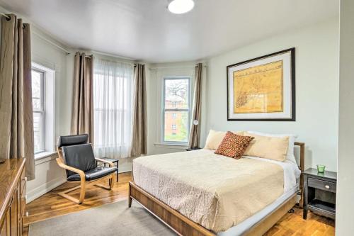 a bedroom with a bed and a chair and windows at Hartford Vacation Rental - Close to Downtown! in Hartford