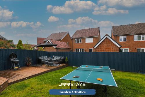 a ping pong table in the backyard of a house at Chorley - Large 3 Bedroom Sleeps 6, Wi-Fi, Garden - JRR Stays in Leyland