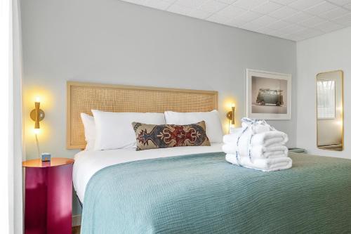 um quarto com uma cama grande e toalhas em The Starlight Motor Inn em Charleston