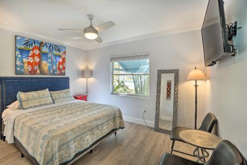 a bedroom with a bed and a tv and a chair at Indian Rocks Beach Duplex, Close to Beaches! in Clearwater Beach