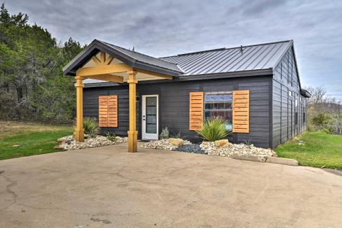a small house with a gambrel roof at Graford Cabin with Rooftop Deck and Lake Views! in Graford