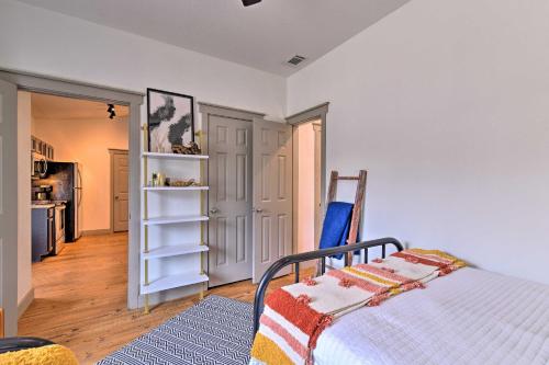 a bedroom with a bed and a kitchen at Graford Cabin with Rooftop Deck and Lake Views! in Graford