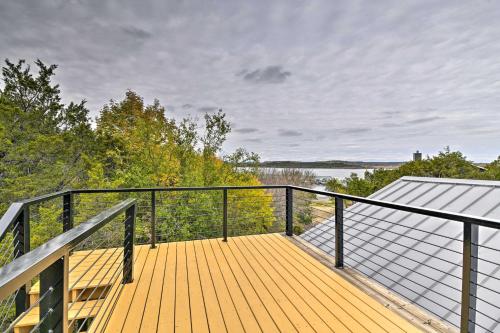 a large deck with a view of the water at Graford Cabin with Rooftop Deck and Lake Views! in Graford