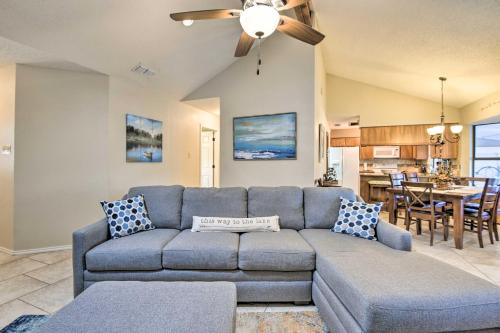 a living room with a blue couch and a kitchen at Granbury Home with Lake Granbury Access and Dock! in Granbury
