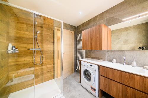 a bathroom with a washing machine and a shower at Villa Santa Maria in Lovero Valtellino