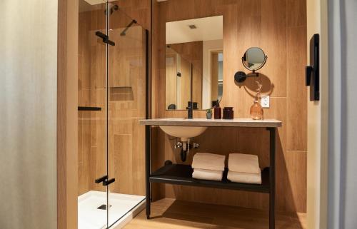 a bathroom with a sink and a shower at Forest Park Hotel in Jasper