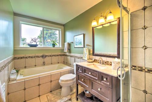 a bathroom with a tub and a toilet and a sink at Fort Bragg Home, Close to Laguna Point Beach! in Fort Bragg