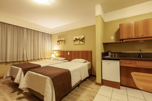 Tri Hotel Executive Caxiasにあるベッド
