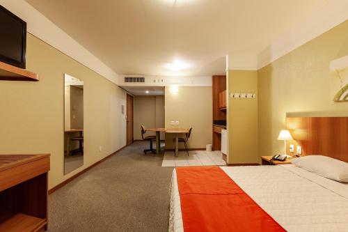 Tri Hotel Executive Caxiasにあるベッド