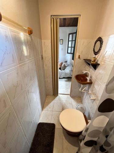 a bathroom with a toilet and a shower at Coco Suites in Abraão