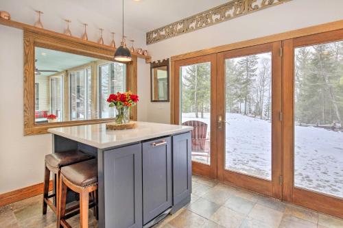 a kitchen with a counter with a vase of flowers at Cabin on Lake Superior about 11 Mi to Bayfield! in Washburn