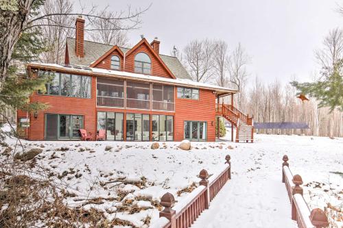 a house in the snow with a fence at Cabin on Lake Superior about 11 Mi to Bayfield! in Washburn