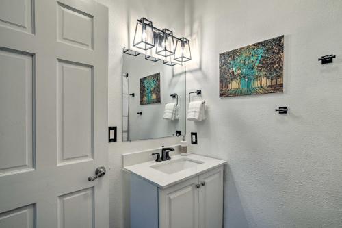 a white bathroom with a sink and a mirror at Stylish Klamath Falls Unit Less Than half Mi to OIT! in Klamath Falls