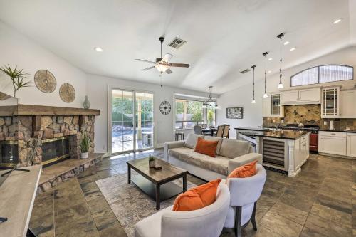 a living room with a couch and a fireplace at Tee Off, Relax Poolside! Family Home in Scottsdale in Scottsdale